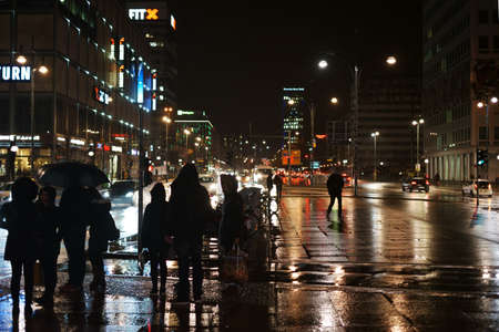 Berlin, Germany - January 03, 2018: Alexanderplatz in the rain with department stores and shopping malls at night on January 03, 2018 in Berlin.のeditorial素材