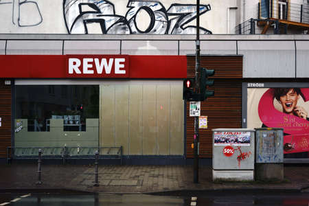 Frankfurt, Germany - February 11, 2018: The REWE food market with an overseas advertising poster in the trendy Roedelheim district on 11 February 11, 2018 in Frankfurt.のeditorial素材