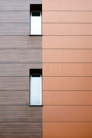 The modern facade of a building with noble wood paneling.                              