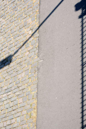 The close up of a walkway on a bridge whose railings throws symmetrical shadows.                   の写真素材