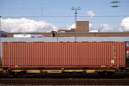 The side view of a railroad car of a freight train at the platform of the Opel plant in...