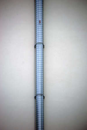 A Drainpipe on a new outer plaster wall .