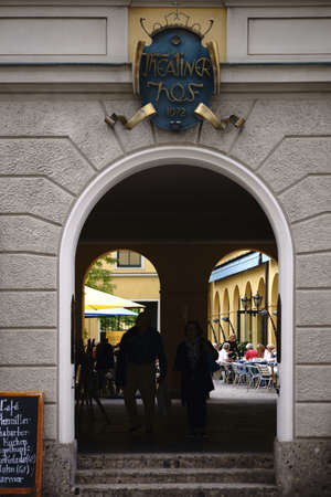 Munich, Germany - June 30, 2018: The entrance and gate to the Theatinerhof a small square with shops...