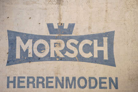 Saarbruecken, Germany - July 29, 2018: The Vintage Logo of Morsch Men's Fashion House on a beige brick facade on July 29, 2018 Saarbruecken.のeditorial素材