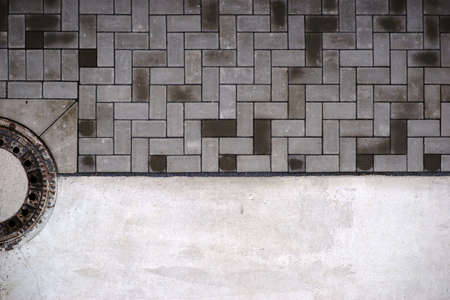 The aerial view and top view of a walkway with paving stones and a gully.