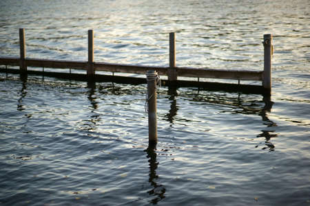 The construction of a fish trap in the evening light near the shore.の写真素材