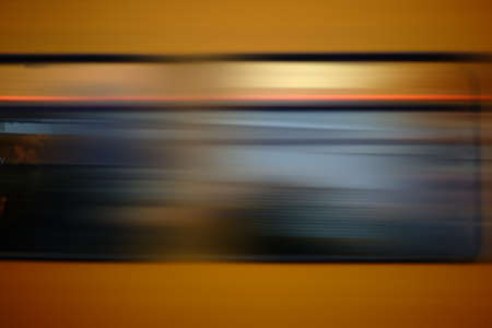 The abstract motion blur of a passing yellow train.の写真素材