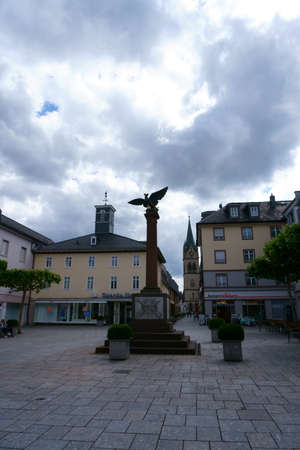 Bad Homburg, Germany - June 09, 2019: The war memorial on the Waisenhausplatz with adjoining shops on June 09, 2019 in Bad Homburg.のeditorial素材