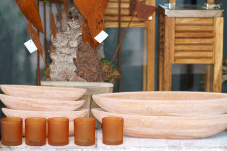 Various clay bowls or bowls made of terracotta on a sales stall with artisanal objects.の写真素材