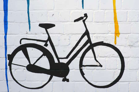 The drawing and the outline of a bicycle on a wall with color gradients.