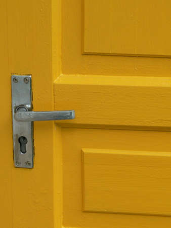 Yellow door with handleの写真素材