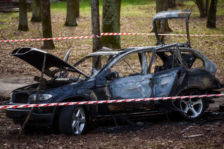 RIGA, LATVIA. 15th April 2021. Burnt BMW X5 car. Possible vehicle of football agent Romans Bezzubovs murders.のeditorial素材