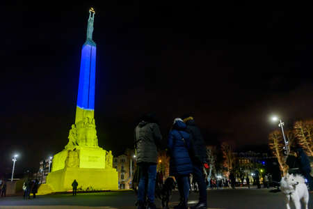 RIGA, LATVIA. 25th February 2022. Monument of Freedom lighted up in Ukraine flag colours.のeditorial素材
