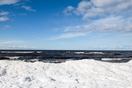 Gulf of Riga in its winter coat.  Deep blue waters meeting the frozen shoreline.の写真素材