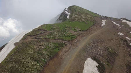 Way to the top of stone column peak from flying up drone