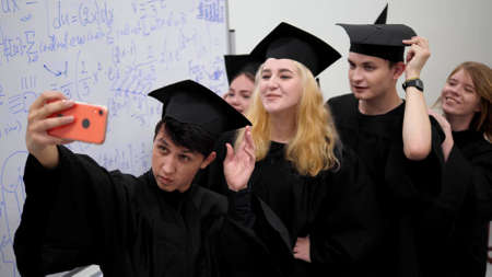 Group of students make photo in classroom.