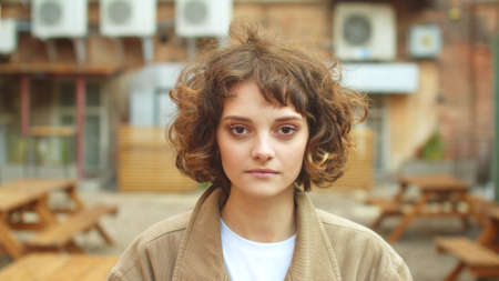 Girl stand on the street, look at the camera with serious faceの写真素材