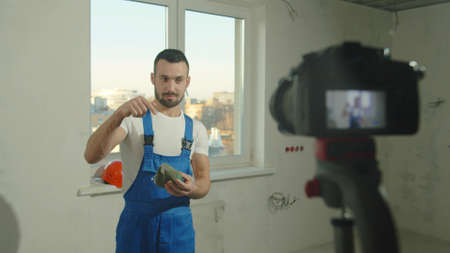 Builder puts on protective mask and talks on camera