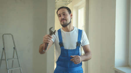 Builder stands and looks at the instrument
