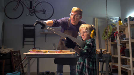 Slow motion, boy plays with a wooden machine gun