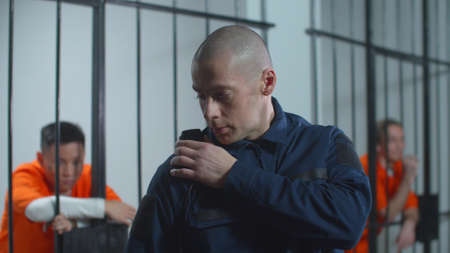 Prison guard talking on the walkie-talkie