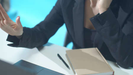 A woman in a suit calls a business partner and talks seriously. Slidingの写真素材