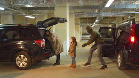 Abduction of a girl in a parking lot while mom was busyの写真素材