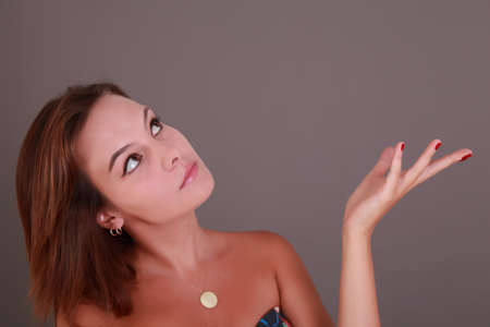 Young beautiful femail brown hair looking upの写真素材