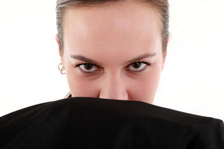 Close up and portrait of mistery woman with black mantleの写真素材