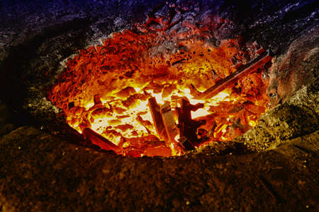 Melting iron pieces in a furnace holeの写真素材