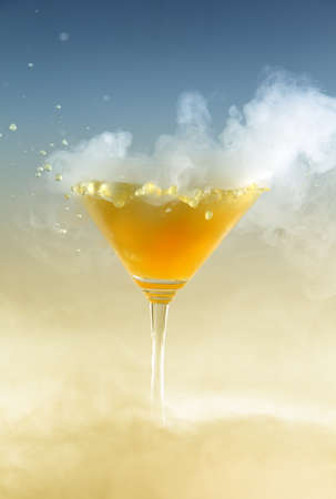 Vertical photo of a splash colored drink with smokeの写真素材
