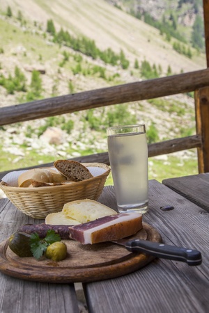 Plate of typical products of Tyrol  Italy  served on the classic wooden chopping boardの写真素材