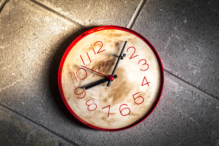 Clock with hands locked by a nail as a symbol of wanting to stop timeの写真素材