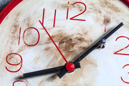 Clock with hands locked by a nail as a symbol of wanting to stop timeの写真素材