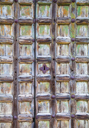 Old wooden door with rusty handlesの写真素材