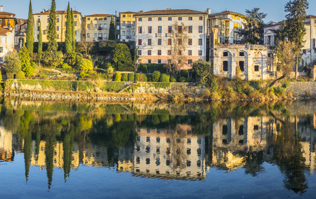 Reflections of the palaces on the banks of the Brenta in Bassano del Grappaの写真素材