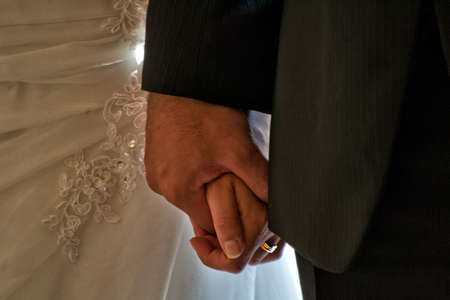 Bride and bridegroom hand by handの写真素材