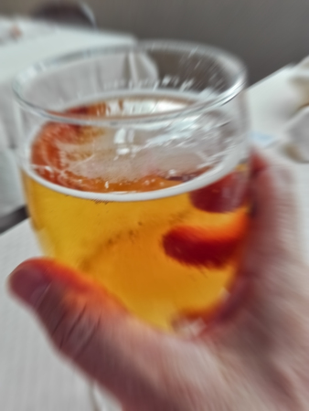 blur picture of a beer glass in man's  hand to simulate overdrinkの写真素材