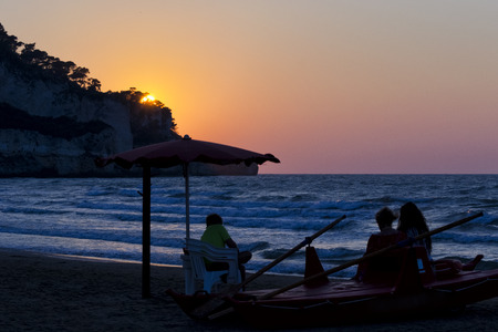 Family watching sunset on a lifeguard boat. for vacation and summer holiday conceptの写真素材