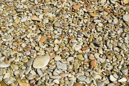 Small stones on a sea beach used as background or texture.  For graphical conceptの写真素材