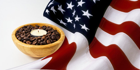 aromatic candle light in a wooden cup with coffee beans and usa flag. for Christmas wishes card and aromatherapy spa conceptの写真素材