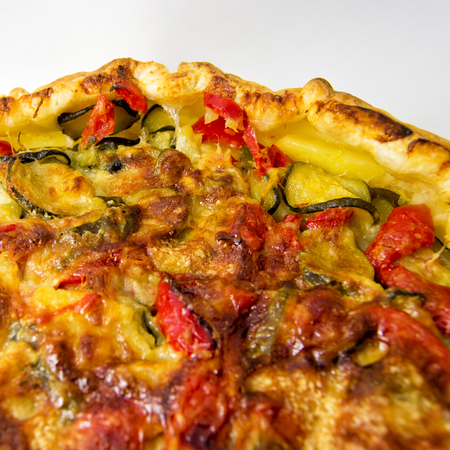 vegetables salad pie. quiche with zucchini, peppers, potatoes and puff pastry. for vegerarian cousine conceptの写真素材