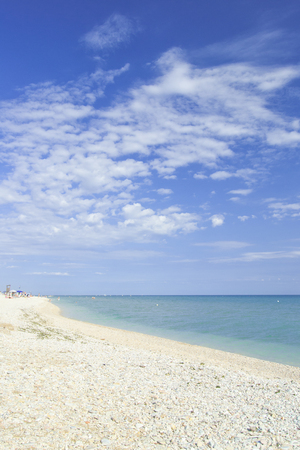 beach of marotta in the italian region of marche during summer with parasols and cloudsの写真素材