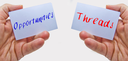 man hands holding cards with the words oppurtunities and threads for swot analysisの写真素材