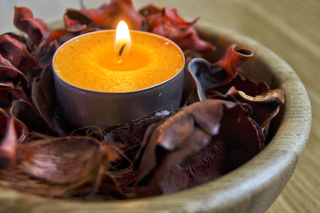 yellow candle light with potpourri for spa and christmas decoration conceptの写真素材