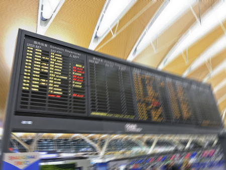 21 09 2018 Shanghai, China - blurred image of airport time table with flight boarding time in chinese airport (PuDong intercontinental airport)のeditorial素材