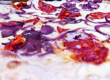 tasty delicious round italian traditional pizza with fresh natural ingredients with onions and spicy peppersの写真素材