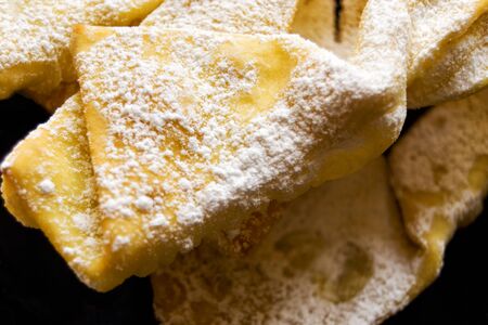 Angel wings:  traditional sweet crisp pastry for carnival time. Italian cenci, frappe, bugie or chiacchiere Italian cenci, frappe, bugie or chiacchiereの写真素材