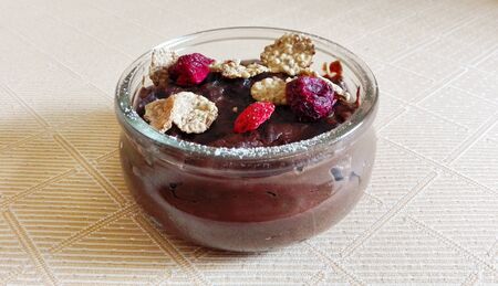 chocolate budino with dryed raspberries and corn flakes in a glass jarの写真素材