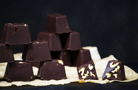 homemade chocolates with nuts on a black backgound - food conceptsの写真素材